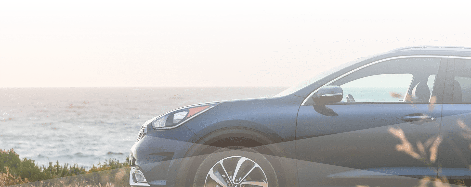 Car watching the sunset over the ocean